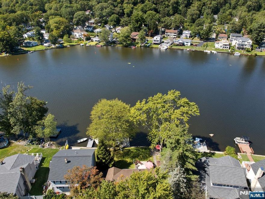 Welcome to your dream LAKEFRONT RANCH in Indian Lake. Rare 1 floor living w/potential. Spacious footprint on a lot & a half leveled property, breathtaking views & inviting backyard. Abundance of back windows radiates natural light, creating a warm & inviting interior ambiance. Charming Front Porch takes you into the updated kitchen w/SS appliances, quality cabinetry, breakfast bar & skylight. This is the heart of the home, open to all living spaces. Meals can be passed through to the Grand Dining Room. Whether relaxing in the Living or Family Room, you can soak up lake & seasonal views. Family Room features corner gas fireplace enhancing the rooms warmth & sliders to the back deck. 3 bedrooms with largest one offering pretty Lake views. One BDRM used as an office w/Murphy Bed which will be sold with the home. Updated 2 sink main bath, powder room, laundry/mud room & garage used as storage & shed space currently. Could be easily converted back. The serene & picturesque backyard is a winner. Beautiful deck, patio & dock will make any lake lover want to move right in. Well maintained home, lots of TLC! Boating, Fishing, Swimming & Ice-Skating are just a few of the fun activities this property has to offer w/many housed at the active & vibrant community club like the 4th of July boat show & FUN weekend. This is the lifestyle anyone would want. Mins to DWTN Denville to explore shopping, restaurants & events. A commuters delight w/hwys, train & bus direct in NYC. TOP schools.