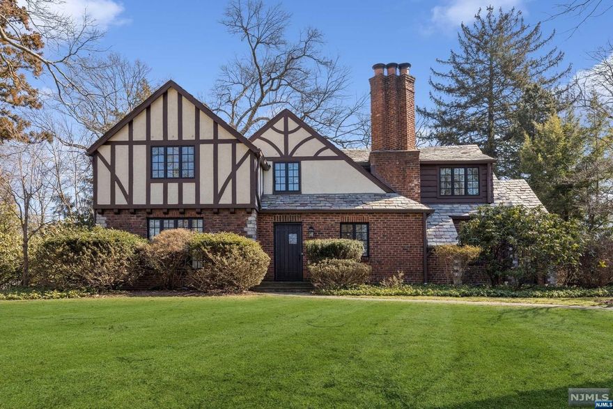 Nestled on sought after Park St, this 1929 Tudor home underwent a complete reno while preserving its old world charm. With 6 br's & 4.5 bathrms, the residence greets you w/a spacious family rm showcasing exposed beam ceilings, stone fireplace, a cozy window seat & antique wood floors throughout the home . French doors lead to a sunrm & the formal dining is perfect 4 entertaining. The eat-in kitchen features Wolf/Sub Zero appliances, granite countertops & a sunny breakfast area. The main level also has a mudrm, full bath & bedrm/office. Upstairs, you'll find a generous master suite w/spa bath, 3 addtl br's and a designer bath . The lower level offers a large rec. rm, half bath & laundry rm. The patio overlooks a bucolic lush yard & the 2 car garage/carriage house includes an apt w/ kit, br, fam rm, & full bath. Ideal for home office or guest suite. Other features include a generator and radiant heating. A dream home!