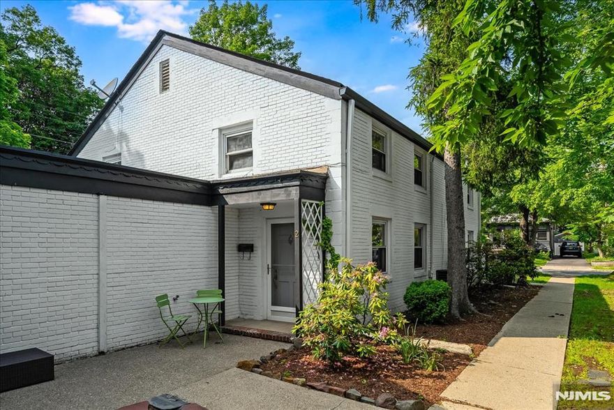 here's just something about these sweet, white brick townhouses, tucked away in the middle of Upper Montclair Village, but so private! The large, bright Living Room has hardwood floors, recessed lighting, walk-in closet and plenty of room to entertain. The formal Dining Room is also a great spot for an office. The Kitchen has granite counters, plenty of counterspace and another entrance out to the patio and attached Garage. First floor Laundry too! Upstairs, two spacious Bedrooms and a Full Bath plus extra closet space. Your own attached Garage with additional parking in front of it. Lovely arbor and patio out back, room for more seating out front. And all just around the corner from Upper Montclair Village, NYC mid-town direct train, Anderson Park and more! Central Air and hardwood floors throughout. It's not too big, it's not too small - it's just right! Welcome home!