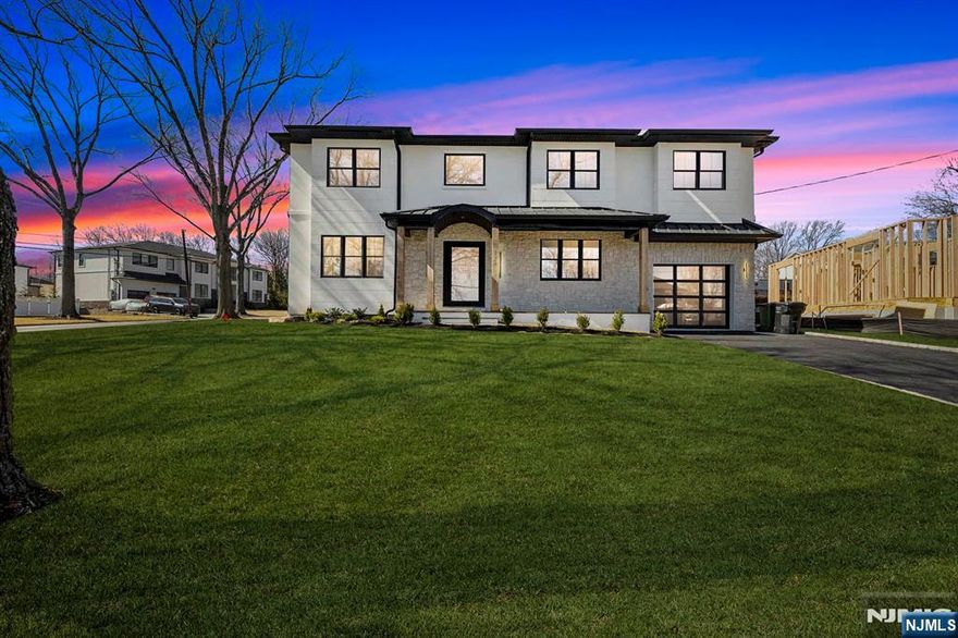 Located on the highly sought East side of Paramus, is charming new construction (on existing foundation), w/ European inspired front porch & European white stone & black accents throughout . This local builder has an established keen eye for detail throughout the home. Modern refinement throughout w/ oversized front entry glass pivot door, soaring 20â€™ entry ceiling, floating steel & wood slab stairs, & double sided modern linear fireplace. The wide plank white oak floors carried create a feel of opulence. Custom White oak cabinetry kitchen w/ a soft stone countertop. 1st floor en suite guest bedroom . Ceiling details are carried throughout the massive bedrooms upstairs, all full w/ extra closet spaces . A grand upstairs hallway carries you to the Master Suite w/ oversized walk in closets w/ custom finishes, Juliet balcony, & the full en-suite w/ double vanity, a soaking tub, & custom shower. The VIRTUAL TOUR link contains a comprehensive video tour, floor plans, & complete interactive 3D model of the home.
