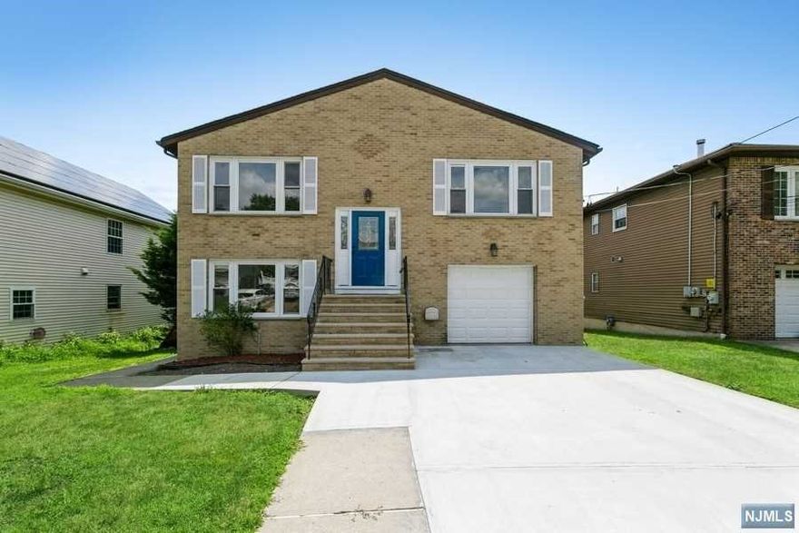 Beautiful extended family home on a quite block in Hasbrouck Height. Completely renovated oversized split level features all new hardwood flooring thought-out the main floor. Beautiful Open concept kitchen features granite counters, ceramic tile floor, back splash, stainless steel appliances such as microwave, refrigerator, stove, & dishwasher. A spacious living and dining room, master suite w/ private bath, 2 good size bedrooms and additional bathroom. The ground level features a kitchen, 2 bedroom and living room with waterproof vinyl flooring. Separate side entrance, full bath, laundry room, and access to 2 car garage. Energy saving solar panels lower monthly utility bills. Central a/c, multi zone gas heat. Easy to commute to NYC minutes from route 80 and route 46 , parkway , and turnpike...