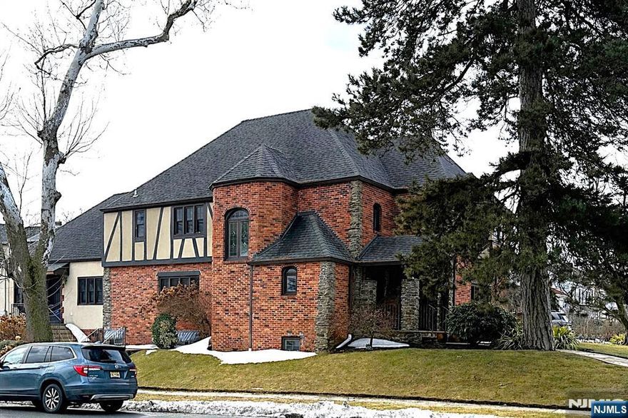 One-of-a-Kind Tudor located at Belgrove Drive Estates - One of the Most Pristine Streets in Kearny! This Spectacular Home offers Approx. 3,700 sq ft of Living Space. 1st Floor Welcomes you with a Grand Entry Foyer, Sunken Living Room with Wood-Burning Marble Fireplace, Modern Chef's Kitchen w/Center Island adjacent to the Family Room, Banquet Size Dining Room, Sun Room with Skylights & French doors, and a Powder Room. Also on the 1st Fl is a Secondary Suite with its own Separate Entrance; ideal for Professionals, Extended Family or Guests - Complete with a Living Room, 2 Bedrooms, and a Full Bath. 2nd Floor Features a Large Primary Suite w/Full Bath & Jacuzzi Tub, a Jr Suite w/its own Full Bath, 2 additional Generously Sized Bedrooms (One with a Sitting Room), and another Full Bath. Ground-Level Walk-Out Basement is Full and Partly Finished, offering a Large Rec Room, Powder Room, Laundry Room, Workshop, Utility Room and Storage. Additional Features include a Gated 4-Car Driveway, an Oversized 2-Car Garage, Outdoor Patio Area, Hardwood Floors, Indian Slate Natural Stone, Granite Countertops, 5 Zone Heating and Central Air. An Absolutely Exceptional Home that is Close to Everything - A True Must See!!!