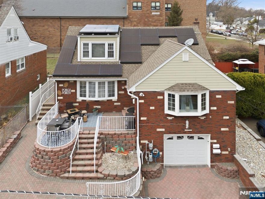 Exceptional and beautifully maintained two-family residence offering space, style, and modern upgrades throughout. This impressive property features 5 bedrooms and 3 full bathrooms, providing comfortable and versatile living. The first floor, renovated within the last five years, showcases a modern eat-in kitchen with quartz countertops, a charming coffee nook, and hardwood floors throughout, along with 3 bedrooms and 1 full bath. The second-floor unit offers 2 bedrooms and 1 full bath, with a kitchen updated in 2025. The finished basement adds valuable living space with a summer kitchen, family room, bonus room, and laundry area. Additional highlights include central air and heat throughout the home, newer windows, newer roof and siding, solar panels, water softener system, built-in speaker system, and a security system. The property also features an attached one-car garage, ample storage, and plenty of closets throughout the entire home. Enjoy outdoor living with a welcoming front terrace perfect for relaxing on summer days and a fully fenced backyard offering privacy and space for entertaining. A wonderful opportunity for owner-occupants or investors seeking a move-in-ready property with modern upgrades.Conveniently located near NYC.