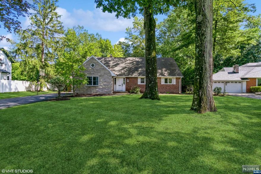 Welcome to this special, rare property located on one of the most prestigious streets in Tenafly. This unique home boasts a beautiful entry foyer, with an oversized living room and a cozy fireplace. The eat-in-kitchen and dining room offer tons of natural light. Enjoy relaxation in the adjacent sunroom/ playroom. The first floor offers a bedroom or library, with a full bath, as well as the laundry room and office. Upstairs are three large bedrooms and a full bathroom. Full basement.