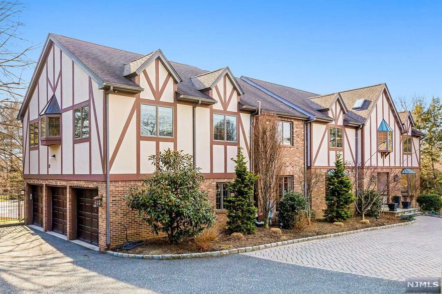 Perched high in the East Hill of Cresskill on a cul-de-sac, this luxurious 5 BR 6 1/2 BTH estate is the picture-perfect complement of warmth and grandeur. Stunning Great room filled with natural light, features a floor to ceiling stone fireplace & built-in wet bar. Affording a sparkling view of the salt water pool, custom chef's kitchen pairs high end appliances w/ a Mondariz granite island. French door opens to stone patio w/ natural gas grill & retractable awning. Elegant formal living room & dining rm offer more entertaining space. BR suite on main fl. Primary suite features a walk-in closet, double vanity & steam shower. Executive home office & upstairs sitting room enhance the fine living style. The lower Level offers gym, media rm & wine cellar. Security syst., generator, smart thermostats, Tesla charger & 3 car heated garage. Only 30 min to the heart of Manhattan, this sophisticated property sitting atop one of Bergen county's most prestigious neighborhoods, is a must see!