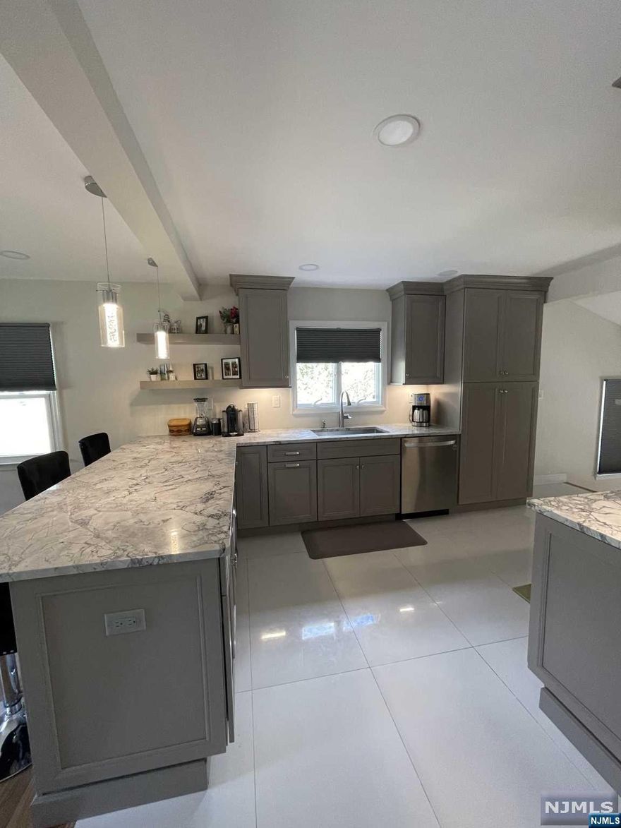 Very deceiving, much larger than appears! Here is the beautifully renovated turn key home you have been waiting for at a price you can afford! Lovely open layout, light & bright with gorgeous brand new kitchen w/granite counters/breakfast counter/SS appliances & tile flooring, refinished HW fls., 1st. fl MBR w/full bth & brand new huge walk in closet w/SGD to deck and newly fenced in private yard/shed, 2nd floor offers 2 additional bedrooms w/new carpet, full newly finished basement w/laundry & closets, brand new energy efficient tankless wall hung boiler w/baseboard heat throughout, LED lighting/electric throughout, brand new Roof, Siding, gutter and leaders, front door, professionally landscaped, Newly paved driveway, entire interior just painted, new interior railings & windows replaced, U/G sprinklers, Wonderful neighborhood close to shopping and major highways! You will love this home the minute you walk in the door! Listing agent related to seller.