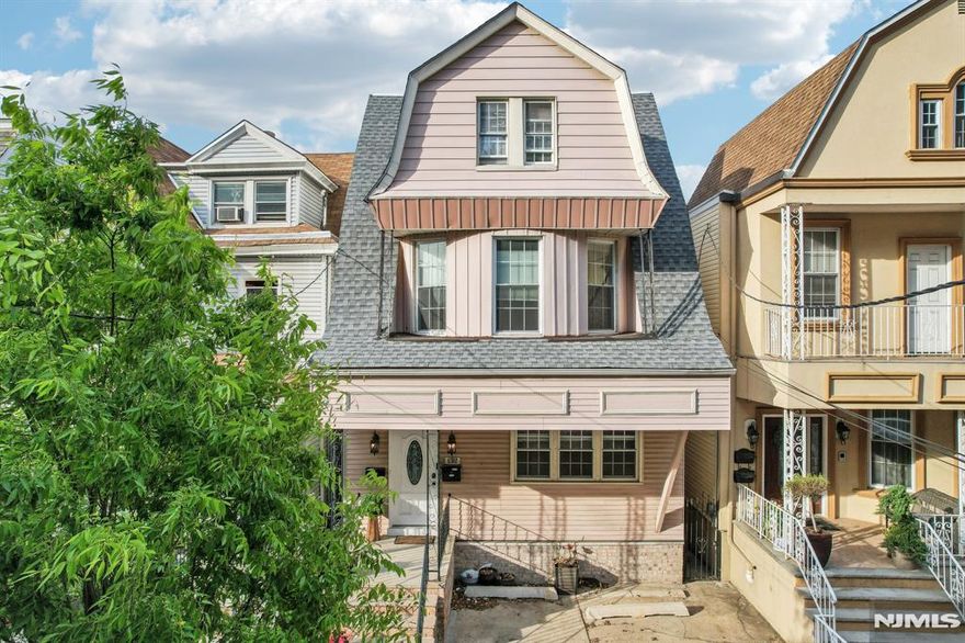 Nestled on a picturesque, tree-lined street in one of Jersey City's most sought-after historic districts, 132 Kensington Ave is a beautifully maintained two-family home that seamlessly blends timeless charm with modern comforts. The owner's triplex spans three sun-filled levels, showcasing original architectural details, gleaming hardwood floors, and thoughtfully integrated contemporary updates. Whether you're hosting lively gatherings or enjoying quiet moments, the spacious layout offers versatility and warmth. Step out onto your private deckâ€”a serene retreat perfect for morning coffee, evening soirees, or simply soaking in the neighborhood's ambiance. Complementing the main residence is a separate 2-bedroom, 1-bathroom unit, ideal for generating passive income or accommodating guests. Its prime location places you just a block from the verdant expanses of Lincoln Park and within easy reach of the Journal Square PATH station, ensuring effortless commutes and access to local amenities. This exceptional property offers a rare opportunity to own a piece of Jersey City's rich history while enjoying modern living and investment potential.