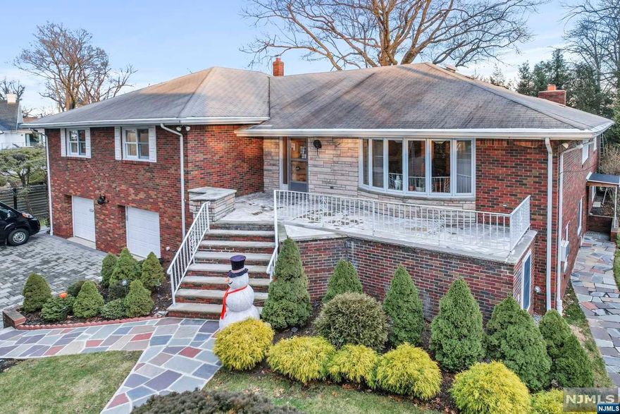 Welcome to this truly unique and incredibly spacious home. Boasting over 5,600 interior sq ft, this mother-daughter style home sits in the highly coveted bluffs area in Fort Lee on a 15,000 sq ft lot! Enjoy having extended family stay on the lower level with its own separate entrance, generous sized bedroom, separate kitchen, bathroom, & an extra room which could very easily be converted into another bedroom! You will find another full bathroom, entrance to the backyard, a massive 2-car garage, & a large laundry/utility room! Upstairs, you will find very large rooms throughout, including 3 bedrooms, 2 full bathrooms, large living, dining, & family room with a fireplace. Plenty of parking space with a driveway that could fit 8 cars! The backyard is a private, tree-lined oasis where you can have barbecues & large gatherings with plenty of room for people to run around. Do not miss your chance to own this very special & rare home in one of the most desirable locations in Fort Lee!