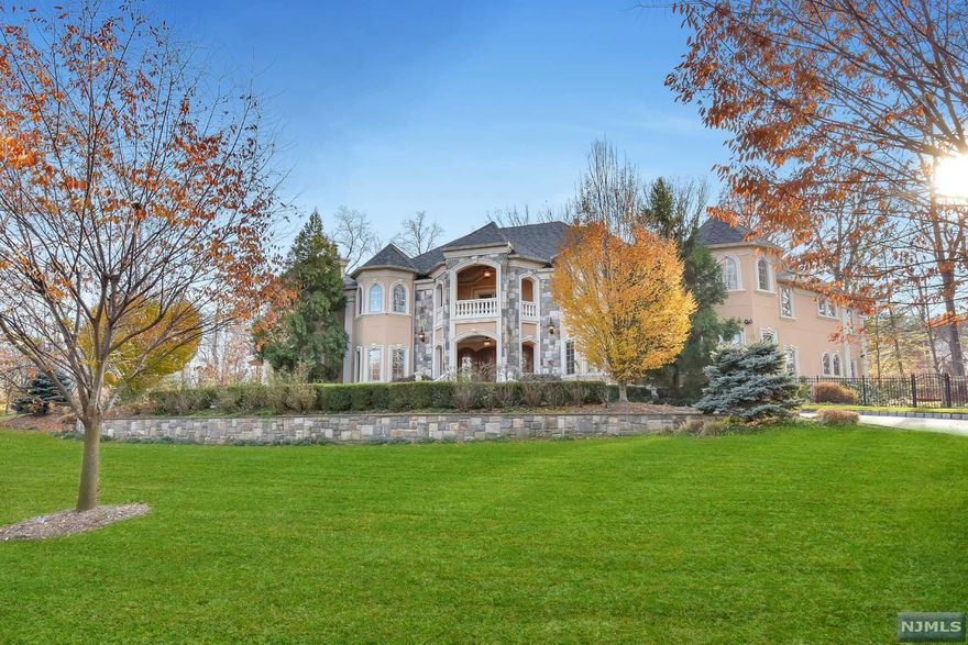 Enter through the magnificent 2-story foyer with double bridal staircase into this amazing 10,000 sq. ft estate with custom millwork, crown moldings, cherry hardwood and marble flooring throughout. No expense was spared in every detail of this spectacular 7 bedroom, 8 full and 2 half bath home. The open floor plan on the first level boasts the formal living and dining rooms, family room with coffered ceilings and fireplace, study/office and poker/gaming room. The chef's dream eat-in kitchen boasts stainless steel appliances, custom cabinetry, double granite islands & breakfast room with fireplace. The over-sized master suite is complete with a luxurious master bathroom, 2 fireplaces, two walk-in closets and 2 private balconies. Completing the second floor are 4 additional bedroom suites with full baths & walk-in closets. The 3 car attached garage, full finished lower level, beautiful backyard, outdoor kitchen and in-ground swimming pool make this the perfect home for entertaining!