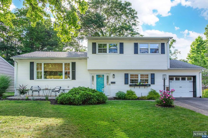 This captivating Bi Level split home bathed in natural light promises to elevate your lifestyle. The kitchen, with custom cabinetry and sleek countertops, integrates seamlessly with the living and dining areas. An expansive family room, an additional guest bedroom, and a closed in sun porch provide comfort and relaxation. Three generously sized bedrooms await, along with a dedicated home office or gym. And don't miss the surprise: your very own tiki room or speakeasy! With central air conditioning, full-property irrigation, and a Nest smart thermostat, this mid-century masterpiece is a must see. Plus, enjoy an NYC commute at your doorstep and all that Montclair has to offer!