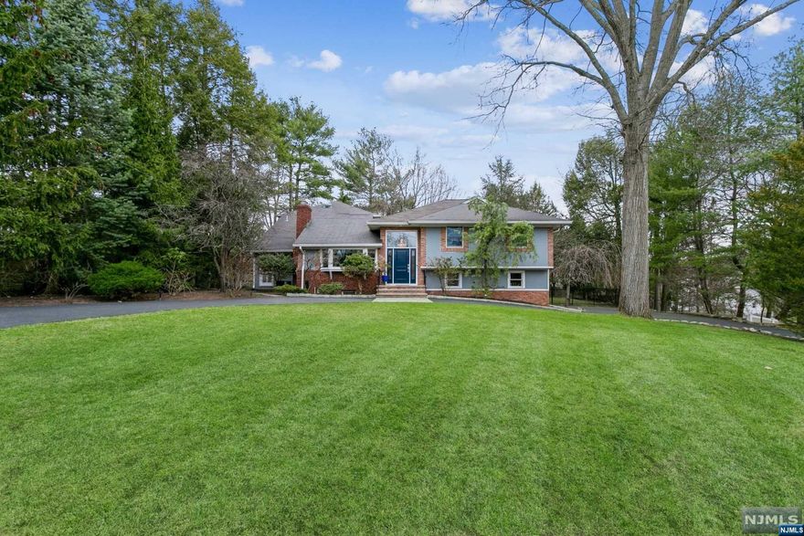 Welcome to this stunning property that boasts an impressive array of features that are sure to impress. Step inside the welcoming entry foyer, you'll be greeted by a sense of warmth and elegance that permeates throughout the entire home. The beautiful living room, complete with a wood burning fireplace, provides the perfect ambiance. The recently updated kitchen with granite countertops is very welcoming. The spacious dining room is ideal for hosting dinner parties, the FR offers comfortable space for relaxation and casual gatherings. With four bedrooms and three full baths, this home provides plenty of space for the household. The fully finished basement with built in bar provides ample room for billiard or ping pong table. The attached two-car garage offers ample storage space for vehicles and outdoor equipment. The blue stone patio provides a wonderful space for outdoor dining and entertaining, while the circular driveway offers ample parking for guests.