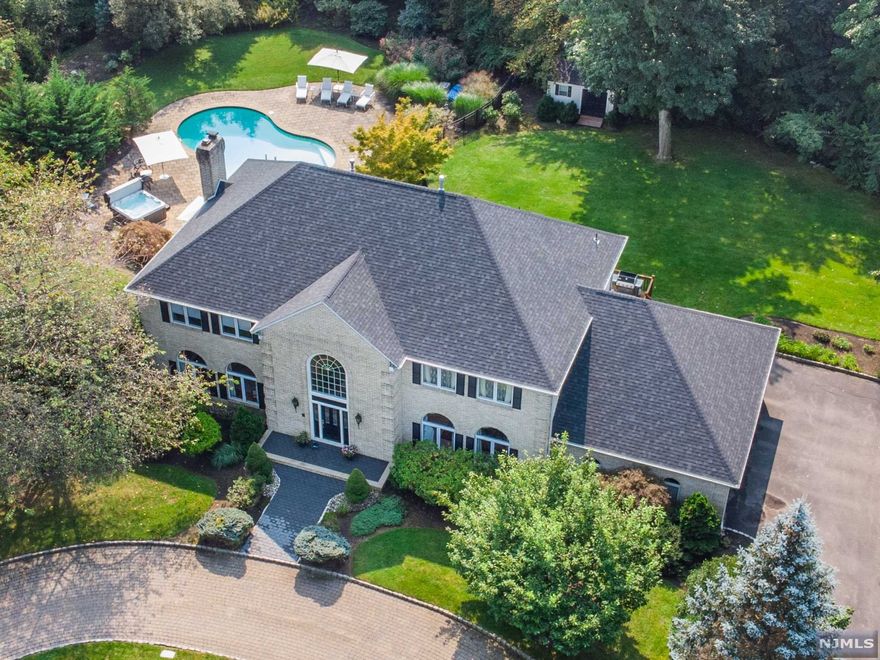 Luxury Living at your Private Oasis! Stately Brick Front Colonial situated on beautiful corner lot w-3 Car Gar, circ driveway & I/G heated Salt Water pool w-separate hot tub. Features incl: New State of the Art EIK w-Thermador appliances, center isle, wet bar, bev refrig, plus 2 dishwashers, Grand EF, FR w-wall of windows, Generous Sized BRs, MBR Suite w/WICs, laundry/Mud Rm, finished walk out LL w-Office, Media Rm, Rec space, Gym & Guest suite. Relax on the expansive deck overlooking the pool/patio area, private & peaceful park like grounds w-mature landscape. Newer Roof, Newer AC/Heat, New Paver walkway plus more! Meticulously cared w-fabulous entertaining spaces both Inside & Out! Natural Gas & Underground Elect Utilities, Sought-after Kinnelon neighborhood w/Luxury Homes, Conv to Shop, Parks, & Highways.