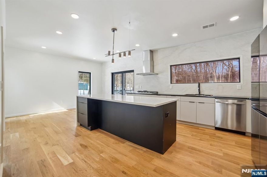 Turnkey - Reimagined with a back addition, renovated & full remodel - Custom unique expansive & open floor plan. Over 3400 Sq ft on 1. 8 Acres - Dramatic curb appeal from the circular driveway. Modern stucco & techwood vertical siding complements the black 8 ft European steel front door & oversized aluminum windows. Everything is sun lit - living room with gas fireplace, dining room with additional seating area. WOW kitchen is what home chefs dream of! Breakfast area, huge Island, cabinets, quartz counters & smart appliances. Convenient powder room & steps down to a family room. Guest bedroom with a bath on this level, laundry room & access to garage with tiled floors, EV charger & wifi door openers. Master bedroom with ensuite & balcony to watch the serene nature. 2 other bedrooms & bath on this level. All closets are walk in with organizers & bathrooms have LED mirrors & towel warmers. 800 Sqf finished lower level offers versatile options. Designer features & fixtures -Wi-Fi enabled 4 zone gas HVAC, exterior lighting, cameras, hardwired TV outlets & ports. New flooring, accent walls, floating stairs, metal railings, solid doors, driveway, electric, insulation (even between floors & walls), plumbing, water softener & hot water heater. Huge Trex deck with gas connection for the grill. The incredibly private wooded backyard offers a retreat to destress or host perfect for summer gatherings. City utilities. Just minutes to highways, NYC train, schools, shopping & restaurants.