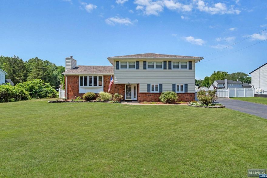 Experience the unique charm of this custom split-level home, meticulously crafted with separation of space and a full in-law suite. Enter a generous foyer leading to a living room with a bay window and cozy fireplace. The kitchen boasts stainless steel appliances, granite countertops, ample counter space, and abundant cabinet storage. The great room, with high ceilings and floor-to-ceiling windows, is filled with natural light. Upstairs, the primary bedroom has a walk-in closet and en-suite bathroom. Two additional large bedrooms and a full bathroom complete this level. The finished basement offers a flexible recreation room. An attached apartment with a separate entrance includes a bedroom, living room, full bathroom, and eat-in kitchen. The sunroom opens to a large backyard with an in-ground pool, ideal for gatherings. Conveniently located with access to NYC transportation, top-rated schools, and close to the Fairfield recreation center and library.