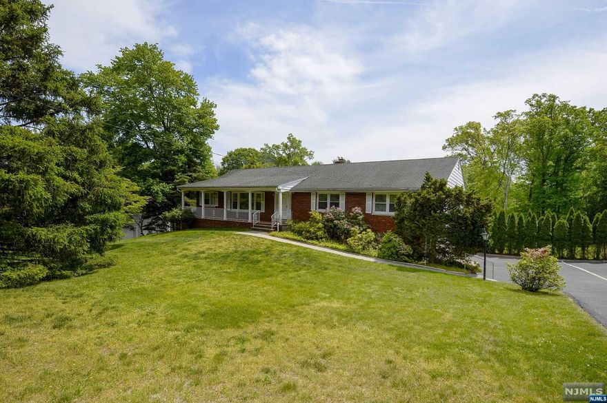 Welcome to this beautiful ranch with wood floors throughout, and a backyard that is serene and parklike. The main floor offers an oversized living room with an abundance of natural light that opens up into the formal dining room. The eat-in-kitchen features lots of space with a bay window overlooking the backyard and is equipped with upgraded stainless steel appliances. From the kitchen, you enter the family room, featuring a fireplace and sliding doors that lead to the deck with spectacular views of the serene backyard. The primary bedroom and en-suite feature ample closet space and natural light. The brand new flooring in the basement compliments the open floor plan and high ceilings, with sliding doors that lead to the patio and pool area where all of your summer gatherings can take place. Two car garage, freshly painted, refinished wood floors, Central Air and over 3,000 square feet of living space. This is a house you can call home!