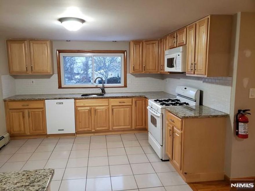 Renovated 2nd-Floor Apartment (2023) Beautiful and bright 2-bedroom unit featuring a spacious living room/dining room combo, an updated eat-in kitchen, and a newer bathroom. The apartment offers multiple closets, hardwood floors throughout, and newer appliances. Washer/dryer hookup available in the basement. Enjoy 2 tandem parking spaces and a highly convenient location with a bus to NYC right across the street. Close to shops and transportation. No pets. No smoking.