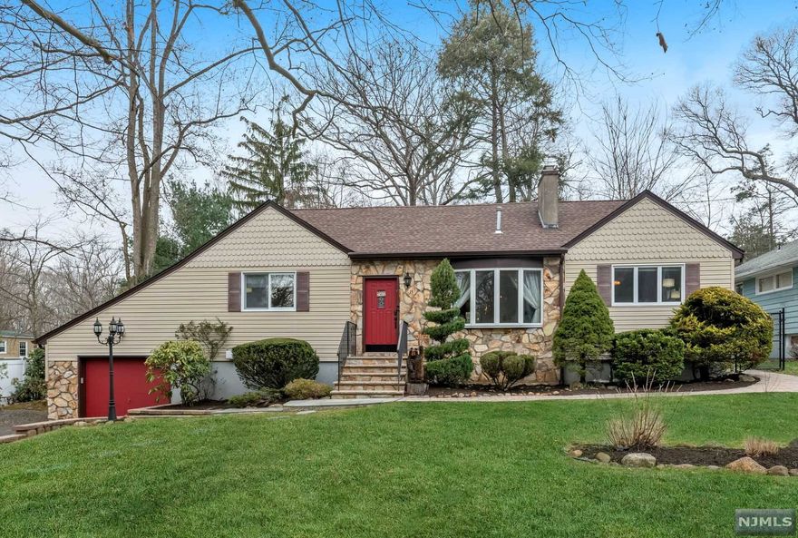 PINES LAKE EXPANDED RANCH! Beautifully maintained home located in this highly sought after lake community that includes swimming, boating, fishing, tennis, social events and more! Light and airy space with open and flexible floor plan that makes entertaining easy! Light and bright front seating area with picture window opens into lovely living room features a stone fireplace and accent lighting. Spacious dining room opens to updated eat in kitchen with stainless appliances. Sliding glass doors lead to rear deck, inviting paver patio and beautiful fenced back yard. The connecting family room features a wet bar and comfortable living space. The main floor also features 3 bedrooms, 2 full baths and hardwood floors. The primary suite is on the second floor with a 15x14 dressing room/closet and full bath. There is an additional bedroom/nursery or office plus lots of storage. The lower level boasts a rec rm and access to oversized garage/workshop. Close to elementary school and beach!