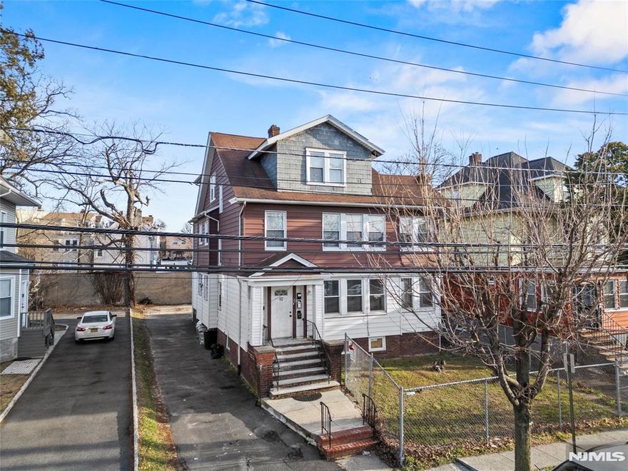 Well-maintained three-family property offering a total of 8 bedrooms and 3.5 bathrooms, ideal for investors or owner-occupants seeking rental income. The fully renovated first-floor unit features a refined, modern kitchen with custom shaker-style cabinetry, sleek black hardware, full-height pantry storage, black subway tile backsplash, and recessed lighting. The kitchen is equipped with stainless steel appliances, including a double-door refrigerator, gas range, dishwasher, and modern vented microwave, creating a functional yet stylish space for everyday living. Washer and dryer hookup adds additional convenience.The second and third floor units are tenant-occupied, providing immediate income. The property includes a full, unfinished basement offering ample storage and future potential. Situated on an oversized lot with a large front, side, and backyard, this home offers rare outdoor space for a multi-family property. Conveniently located near schools, shopping, and transportation to NYC.