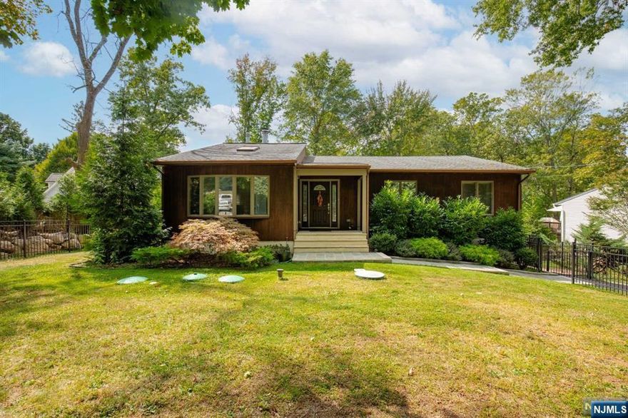 For more information on this home please contact Benny Abramov- 201-747-0564 Step into this 1,632 sq. ft. sunfilled ranch home, perfect for extended living and showcasing true pride of ownership. Enter through the tiled foyer into the living room with cathedral ceiling, skylight, and a masonry fireplace. The dining room, adorned with crown molding, opens to a Trex deck that overlooks a serene, fenced backyard. The gourmet kitchen boasts custom cabinets, tile backsplash, stainless steel appliances, and Corian countertops. Just steps away are two generously sized bedrooms and a tastefully finished full bath. The primary suite offers a walk-in closet and a bathroom with double sinks. The lower level includes a bonus room, entertainment area, full kitchen, laundry/utility room, storage, and a private entrance from the backyard. Located in the coveted Heights school district, this home is a true gem. Perfect for those seeking flexible living spaces.