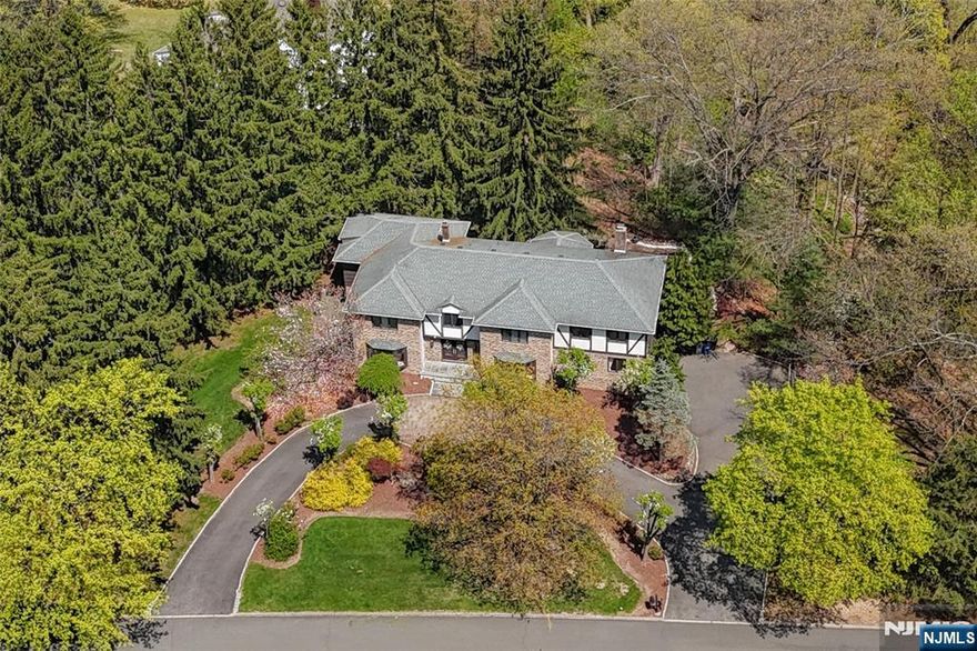 LOCATION! LOCATION! LOCATION! Beautiful center hall colonial w/elegance, charm & custom details located in the desirable Knollwood/Rustic loop in Upper Saddle River overlooking the serene Pleasant Brook. Marble entry foyer. Elegant formal LR w/decorative fireplace. Formal DR w/bay window. Newly updated gourmet chef's kitchen (2023) w/ stainless steel Wolf, Subzero & Cove appliances, quartz countertops, custom cabinetry, large center island, open to sunny breakfast room w/access to deck overlooks peaceful back yard & serene Pleasant Brook. Large front to back family rm w/wood burning fireplace, elaborate built-in cabinetry & trim work, windows surround. Separate office w/private covered patio. Laundry room w/walk-in pantry & PR. Second flr can be accessed by either the center hall or back staircase from the kitchen. Primary BR boasts striking tray ceiling. Stunning, luxury primary bathroom w/radiant heat, high ceilings, gorgeous custom cabinetry, dbl sinks, separate dressing vanity, 2 walk-in closets. 4 additional lrge bedrooms (one currently built-in w/dbl desks as a study). Updated FB w/dbl sink & rain shower. Lower level includes a finished rec rm, a separate den/bonus rm, a full bath, a lrge storage/utility rm, mult storage closets & entry to 2 car garage. Circular drive. Roof replaced (approx 15 yrs). Newer heating sys (2021), tankless HWH & Culligan water sys. Enjoy award winning schools, beautiful parks & recreation, easy access to major highways & transportation.