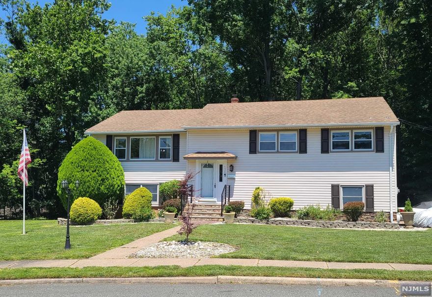 Fantastic property located in an oversized lot professionally landscaped. This Bi-Level house comes with 3 Bedrooms in the upper level, Master suite with renovated full bath, 2 closets one is a walking closet. Spacious additional 2 bedrooms sharing a full bath. Inviting living room with large windows, in an open concept layout with the formal dining area, kitchen with a breakfast island and stainless-steel appliances, and a sliding French door leading to a Deck. In the lower level, we have a large family room, perfect for entertainment, with a bar on it, full bath, laundry room, and 2 attached parking garages, and just step out a paved backyard perfect for outside entertainment. Additional new features: WiFi speakers in master bedroom, Exhaust Attic fan for energy saving, Purified water filter installed for the house, Smart Laundry w/WiFi capabilities, outside light sensors, Sprinkler system for the landscape, New Central Air. Easy access to Transporation by Bus or Train to NYC.