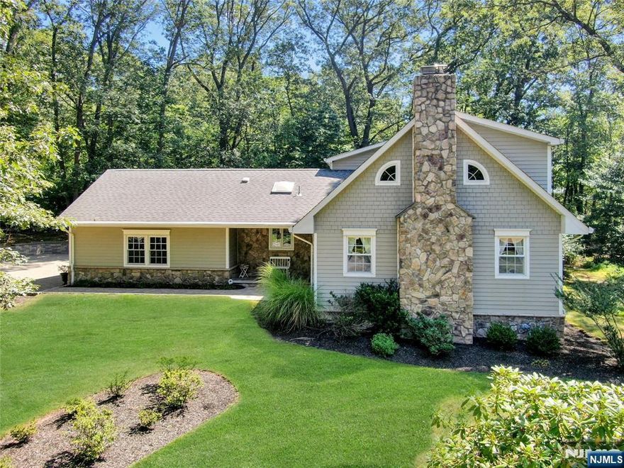 Welcome to this exceptional & remarkable 4 Bedroom 2.5 Bath Custom Nantucket Colonial offering incredible location, wonderful layout, & located on one of the most sought after residential streets in Woodcliff Lake. This home exudes an elegant atmosphere inside & out. Located on the sought after West Side of Woodcliff Lake known for stunning homes & extraordinary properties this picturesque residence exudes a wonderful lifestyle in a serene suburban setting. A long paver driveway sets an elegant tone. The Covered front Porch leads to the spacious Entry Foyer, & the beamed Formal Living Rm w/gas Fireplace & Dining Rm. The Custom Renovated Kitchen is the hub of the home, w/breakfast bar, skylight, custom cabinetry, & Stainless Steel appliances, granite counters, & opens to a Breakfast Rm overlooking spectacular views of the expansive rear yard & Patio. Off the Kitchen is a Laundry Rm & Powder Rm. The Main Level Primary Bedroom Suite has a Primary Bath. The Upper Level Offers three spacious Bedrooms, & a Main Bath/skylight. The Finished Basement has a large Recreation Rm & large storage rm. Hardwood floors are on both levels! This home has everything on your wish list, & is located close to top Rated Woodcliff Lake schools, shopping, & NYC bus & rail. Love it as it is, or Expand on the remarkable property & location of your dreams. It's just a few minutes to Wegmans in Montvale & Trader Joes in Westwood! Outstanding Location! Just move right in & fall in love!