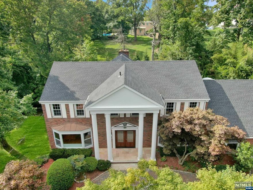 Rarely found Updated Classic Charm Modern Center Hall Colonial Home with 5 Bedroom,4.5 Baths nestled away in a private cul-de-sac in North Cliffs. Main Level offers marble Grand Entrance Foyer, Living Room, Library/Family Rm/w Wood Burning FPL/SGD to Deck/BBQ Grill. Family Room adjacent to Gourmet Granite Kitchen with Center Island, Newer Appliances & French DR to Deck overlooking a Park-Like Property with Serene Stream. Formal Dining Rm & 5th/Guest Bedroom w/ Full Bath. Powder Rm. Upper Level offers updated primary Bedroom Suite with Whirlpool Bath & Walk in Closet.2nd Bedroom with Full Bath & WIC, 3rd & 4th Bedroom and main Full Bath w/Double Sinks. Full finished Spacious Walk out Lower Level with Home Office, Recreation or Gym w/daylight & access to Patio. Hardwood Floor throughout. Circular Driveway. 2 car Garage.14,796 sf property & 3,896 sf living space. Low Property Taxes. Newer Roof & Newly Tiled Deck. Many Updates. Close to Schools, 9W, PP PKWY, GWB, NY BUS & Restaurants