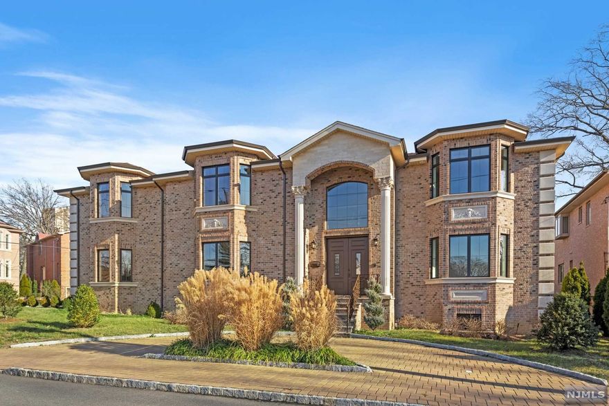 LOCATION,LOCATION,LOCATION...Bluff Area of Fort Lee 3 years old Center Hall Colonial over 7,500Sqft of absolute luxury. Brick & Precast exterior, Marble diamond heated entry foyer with an Exquisite Staircase. Freshly painted Interior with coffered ceilings and crown molding throughout. Superior* Electric fireplace in living room & family room, custom hardwood heated floors throughout, Custom arches and elegant trim, 20ft ceilings in entry foyer and family room. Designer kitchen with soft close Fabuwood* cabinets, Haier* 5 burner gas stove, GE* Refrigerator, Dishwasher, built in Wall oven and microwave, Summit* wine cooler, dry bar with butler pantry, Formal dining room, Library. Mstr Bd/ bath with jets, 4 bedrooms, 3 baths. Finished basement with sauna, bedroom/fullbath and recreation room. 8 zone heat-hydronic and radiant, 4 zone a/c, Nutone* vacuum system and Comelit* intercom/alarm system. Large patio overlooking landscaped backyard, paved circular driveway. Heated 2 car garage