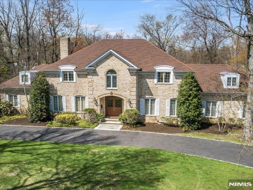 Custom-built original owner home in sought-after Essex Fells, one of northern NJ's most desired communities. Set on an acre in a prime location, the home boasts plenty of curb appeal with its sweeping front lawn, circular driveway and stately double-door entrance. Elegant formal rooms and comfortable living spaces, floor to ceiling windows, French doors, high ceilings and exceptional millwork are all key elements of the interior. Highlights include a double-height Foyer with beautiful turned staircase and leaded glass Palladian window, banquet-sized Dining Room, formal Living Room, vast Family Room with large stone fireplace, cozy Den with fireplace. Large eat-in Kitchen has a casual dining area with lovely panoramic views of the town Skating Pond. Tranquil Primary Suite with en-suite Bath, two walk-in closets and Sitting Room. Three additional Bedrooms and full Bath complete the second level. Fabulous lower level Recreation Room with huge circular wet bar, fireplace and second Kitchen. Essex Fells is a peaceful oasis known for its extraordinary natural beauty and excellent schools - only 23 miles from NYC.
