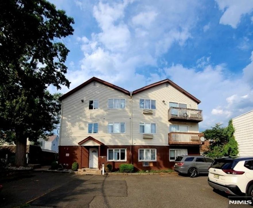 2-bedroom, 1-bath condo available for rent in Passaic. The unit features an open living and dining area with hardwood floors and recessed lighting throughout. Sliding glass doors lead to a private balcony, providing natural light and outdoor space. The kitchen includes all brand-new appliances, including a dishwasher, refrigerator, and electric oven range, along with ample cabinet space. In-unit laundry included. Additional storage available in the attic. One assigned parking space included for the tenant, with one additional guest parking space permitted. Conveniently located near shopping, dining, and major transportation routes.