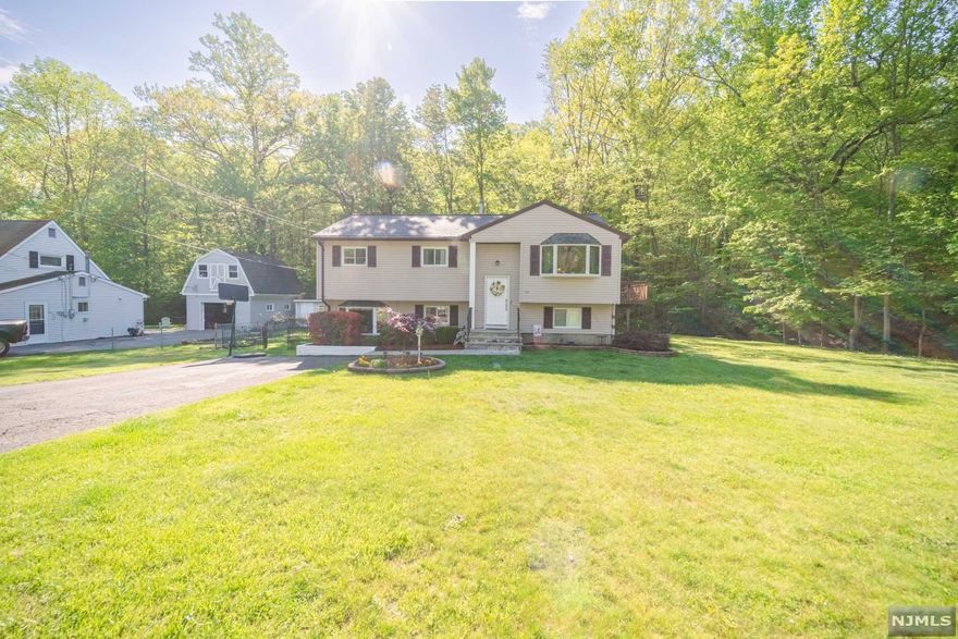 Are you looking for a serene setting? Then Welcome to 43 Morris Ave! This home exudes a comfortable place to lay your head. Surrounded in the back by stateland you will need not worry, the only sounds coming from the woods are birds chirping and frogs singing. This home is a bilevel but with some cool twist. The kitchen is beautifuly updated and the dining room offers sliding doors to the deck where you experience the serenity and many hummingbird sightings. The Primary Bedroom has a well appointed BR. Hardwood Floors thoughtout the first level. The lowere level is the suprise!! It features another bedroom, an office and two family rooms, a full bath and a side entrance, perfect if you are inviting a family to live with you or stay awhile. The icing on the cake is the location of this gem. Located at the west end of the Cresent Park, the street is tree lined and welcoming. This truly is a find.