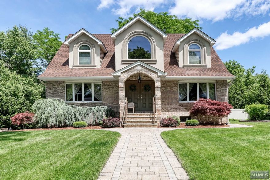 A MUST SEE! This beautiful, immaculate home shows pride of ownership, rebuilt in 2000. Curb appeal invites you into this turn key home with a possible in law suite at the lower level. Greet your guests with the two-story entry foyer. Large open concept kitchen open to a large family room is perfect for entertaining. Both living room and family room are approximately 14 x 23. Total square footage with finished basement is 4400 sq ft. Square footage not including basement is 3200 sq ft. Sliding doors lead to a new large Trex deck. Sitting room can be converted back to a 4th bedroom. Private living on full finished lower level offers a large rec room, wet bar, laundry/ utility room, full bath, private exterior access, built in garage and sound speakers. Private large backyard and long driveway that leads to a detached car garage. Includes wood floors, crown molding, central AC, multi- zone heat, sprinkler system for easy lawn care, and MORE!