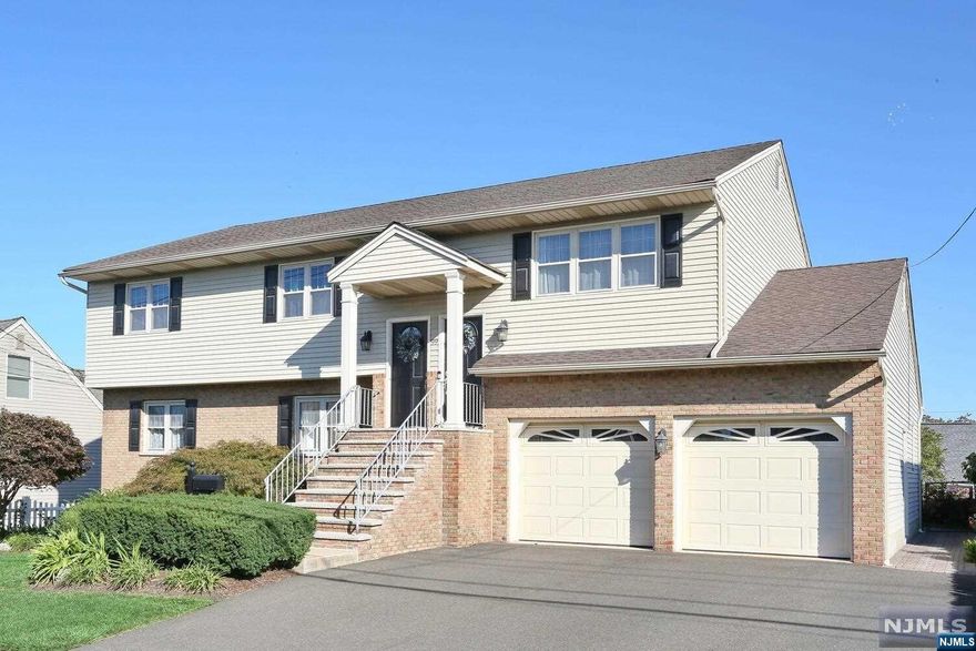 Beautiful large 2 family house with over 4,200 square feet features 5-6 br's, 5 baths plus a fin bsmnt with studio. 1st flr features a living room, large eat-in-kitchen w/ center island, 2 large br's, formal dr (could be a 3rd br), & 2 full baths. 2nd flr features 6 large rooms which include living room, formal dr, large kitchen, master br w/ full bath, 2 br's, & 2nd full bath. Basement with a sep entrance features a large laundry room, studio w/ family room & kitchen area, full bath, & storage room. Sep entrance for 1st & 2nd floor apartments, all sep utilities, central a/c, gas h/w bb heat, hwd floors & ceramic tile floors, 75 x 100 property with fenced-in yard and paver patio off 1st flr kitchen. 2 car att ee garage, 3 car wide driveway, brick & alum siding, house built in 1980 (approx), 2nd flr central a/c completely replaced 2 yrs ago, spacious br's w/ large closets, 2nd flr mbr has walk-in closet plus a double closet, attic strg, close to schools & transportation, wont last.