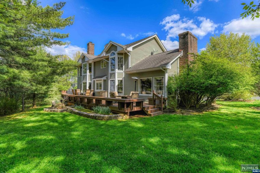 BOM! Welcome to this stunning 4-bedroom, 4-full bath Colonial home located in a serene cul-de-sac. With its elegant two-story ceilings, abundant windows, and charming design, this home offers a perfect blend of comfort and style. The spacious interior boasts two fireplaces, perfect for gathering and relaxation, a custom kitchen, and a large finished basement, while the private yard and expansive deck provide outdoor relaxation and entertainment spaces. Spacious square footage. Welcoming foyer leading to an open floor plan. Two-story ceilings and large windows, allowing for ample natural light. Custom kitchen with upgraded appliances and two ovens for culinary enthusiasts. Custom built-ins in the family room, adding a touch of elegance. The 60-foot deck is ideal for outdoor dining and entertaining Beautiful private yard, offering tranquility and privacy Large finished basement, providing additional living and entertainment space. Close to shops, schools and NYC trains.