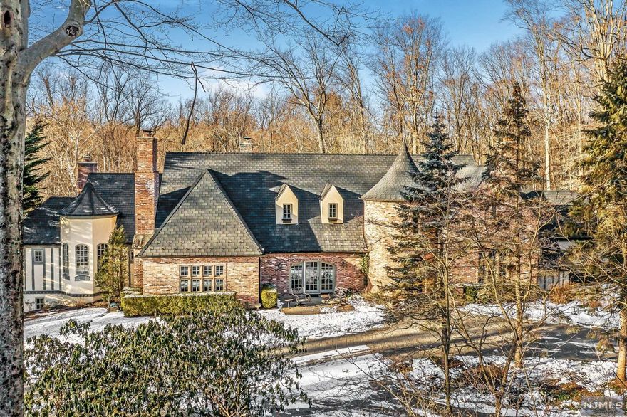 This stunning, architectural masterpiece is a private oasis, situated on almost three acres, in one of the most serene settings in town. With 5 bedrooms, 5 full and 2 half baths, this home offers everything today's buyers are looking for. Luxury features include magnificent woodworking throughout, 5 fireplaces, high end finishes, high ceilings, 3 car garage with Tesla charger, and a gorgeous pool. The first floor boasts a Primary Bedroom Suite complete with sitting room, spacious primary bath with double sinks, shower, tub and a large walk-in closet; Banquet Sized Dining Room, Chef's Kitchen, Family Room, Living Room, Laundry Room and Den. The second floor includes 2 unique bedrooms with a bath and 2 additional bedrooms with a connected bath. The spacious lower level has a walk out to the patio and pool, family room, gym/office, cabana bath with shower, bedroom with bath and ample storage. Don't miss this truly spectacular home!