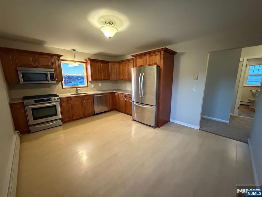Bright and spacious second floor 2 bedrooms apartment with modern eat-in kitchen with SS appliances, brand new carpeting floors, updated full ceramic tile bath. Shared use of large yard included. Ample street parking available. 1 mile to Lyndhurst train station and centrally located near shops, parks, transportation and major highways. Tenant pays all utilities, Landlord pays for cold water. No pets and no smoking of any kind permitted.