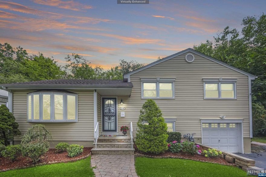 Situated on one of the most desirable streets in town this lovely expanded split level home offers 4 bedrooms 3.5 bath, a large family room with a fire place, skylights and a sliding glass door to a gorgeous yard, Trex deck, patio and a basketball court. On the first floor enter to a foyer, a spacious living room with a new Bay window, the kitchen has all stainless steel appliances and Granite counter tops with a bar over looking the spacious and accommodating family room. Also on the first floor there is a full bath. On the second floor there are three large bedrooms, the primary has half a bath, and there is a main bath on this level. The ground floor offers a bedroom or an office and a full bath. The finished basement has laundry and rec. room. Close to parks, schools, golf course, NYC trans. Enjoy this lovely town with low taxes, proximity to main highways and shops. Home is in excellent condition, roof 3 years, heating, cooling 3 years old, new appliances. Move in ready.