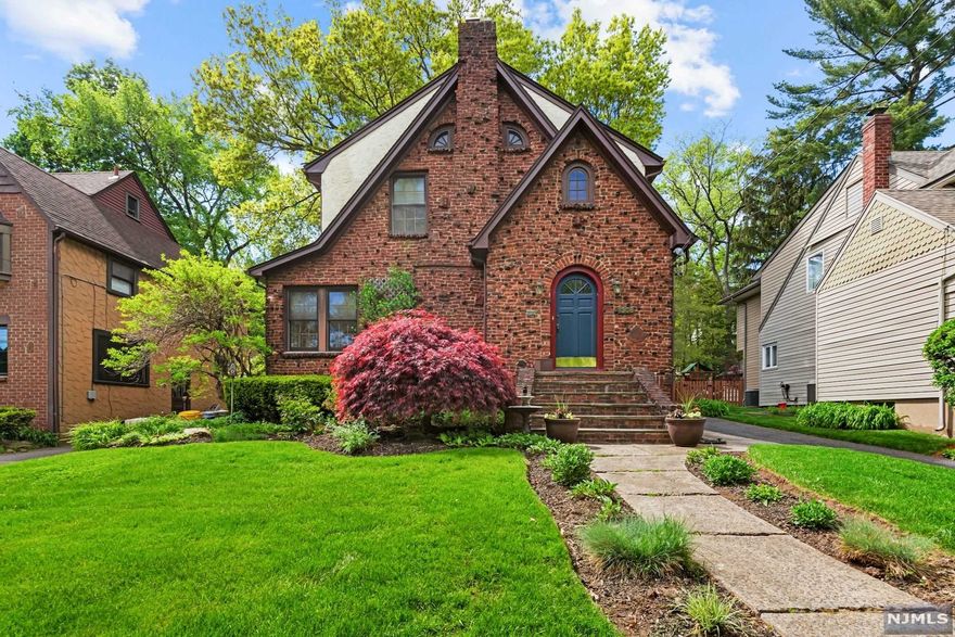 Clinker Brick Tudor Colonial. Updated, open floor plan. New Roof on house and 2 car detached garage - 2020. Foyer with a French glass door, coat closet and powder room. Living room is nearly 30 feet wide with wood-burning fireplace. Kitchen has granite countertops,partial vaulted ceiling with powered skylight, newer stainless steel appliances and large center island open to a formal Dining Room. Wood floors throughout. 1st Floor family room has Jotul, wood burning stove and floor to ceiling windows overlooking a private yard. Perfect for staying cozy on snowy days. 2nd floor has 3 Bedrooms, including the primary, updated bathroom. 3rd floor, finished, brand new skylight with auto remote shade, replaced in 2020 with roof. Laundry, storage and 1/2 bath in Basement. 2 Zone Central Air.