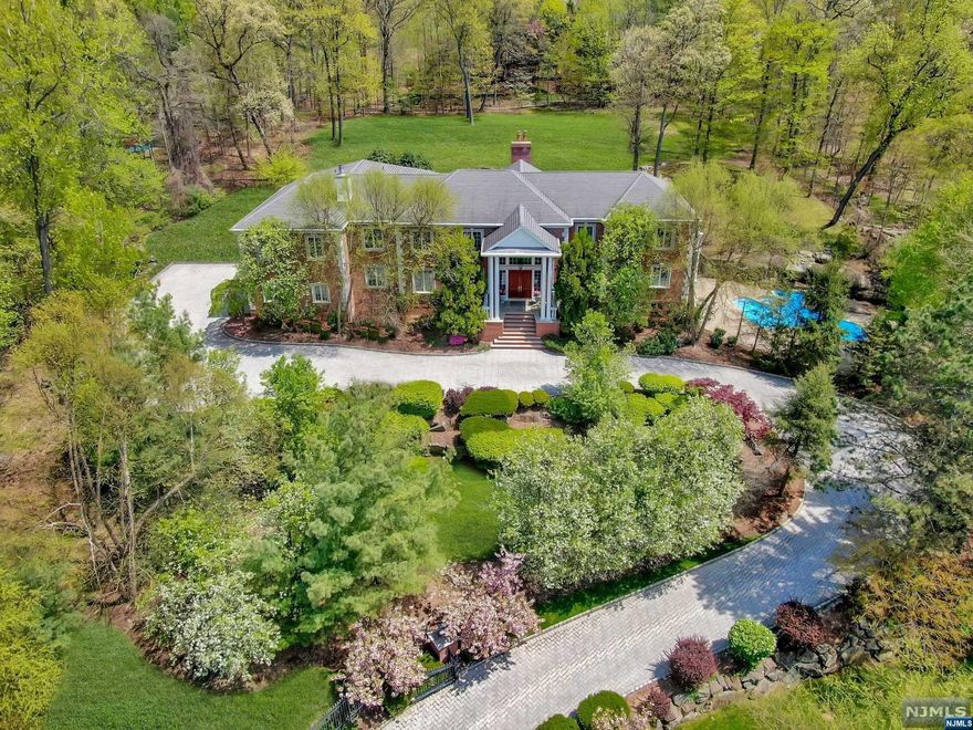 THIS GATED TWO ACRE ESTATE IS THE ESSENCE OF LUXURIOUS LIVING. LOCATED ON ONE OF ALPINE'S MOST DESIRABLE STREETS, THIS CLASSIC AND TIMELESS COLONIAL MANOR OFFERS APPROXIMATELY 11,000 SQ. FT. OF WELL APPOINTED LIVING SPACE WITH AN OPEN FLOOR PLAN DESIGNED FOR TODAY'S CASUAL LIFESTYLE.THE GRAND ENTRANCE FOYER SETS THE TONE FOR THE MAIN LEVEL OFFERING A 2 STORY GREAT ROOM WITH FIREPLACE AND FRENCH DOORS TO THE PATIO AND PRIVATE GROUNDS,FORMAL LIVING ROOM,BANQUET DINING ROOM, OFFICE WITH FIREPLACE,THEATER W/BAR,MEDITATION/YOGA ROOM,BILLIARD AREA & A TRUE CHEF'S KITCHEN W/COMMERCIAL GRADE APPLIANCES,MUD ROOM,LAUNDRY + 2 POWDER ROOMS.THE SECOND LEVEL SHOWCASES A SERENE & TRANQUIL MASTER SUITE W/FPL & MASTER BATH W/STEAM SHOWER & WHIRLPOOL + 2 BALCONIES,4 ADDITIONAL EN-SUITE BEDROOMS,LARGE PLAY ROOM & LOUNGE AREA.LOWER LEVEL IS FINISHED WITH RECREATION AREA,WET BAR,GYM,KITCHEN,BATH & BEDROOM.THIS HOME IS COMPLETE WITH ALL AMENITIES INCLUDING A POOL & GENERATOR. ENJOY ALPINE'S LOW TAXES