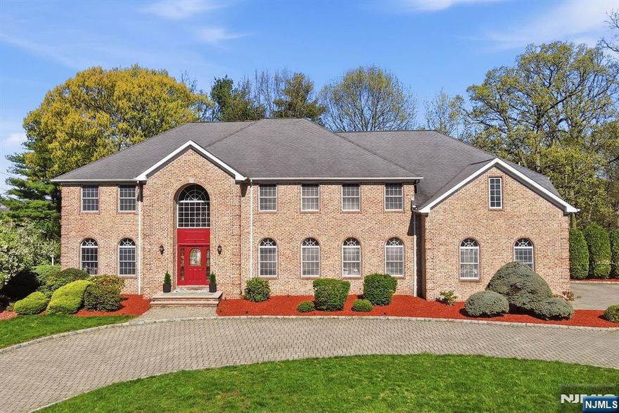 Rare opportunity to own a truly exceptional, resort-like property offering approx. 5,000 sq ft across 2 expansive levels, with room sizes & proportions rarely found in newer construction. This timeless, brick-front Center Hall Colonial, built by a premier builder using materials designed to last a lifetime, combines enduring quality with incredible scale on a beautiful, flat 1/2 acre lot in a desirable neighborhood. A grand 2-story foyer with a sweeping staircase opens to formal living and dining rooms, a private office & a dramatic great room with a fireplace. Hardwood floors span much of the home. The gourmet kitchen features granite countertops, a center island, & ample gathering space. A flexible layout includes a main-level bedroom with a full bath, convenient first-floor laundry and a deck off the kitchen. Upstairs offers oversized bedrooms and a massive primary suite, along with a bonus room ideal for a home office, playroom or lounge. The full walk-out unfinished basement is perfectly usable today and ready to be transformed into a theater, gym or recreation space. Set on a large, flat lot with room for a pool, 6 zone sprinkler system, the home also features a circular paver driveway and a 3-car garage. All this, ONLY $26,575 IN TAXES. Lovingly maintained and completely livable as-is, it offers the rare opportunity to personalize over time blending immediate comfort with long-term value. NOT TO BE MISSED!