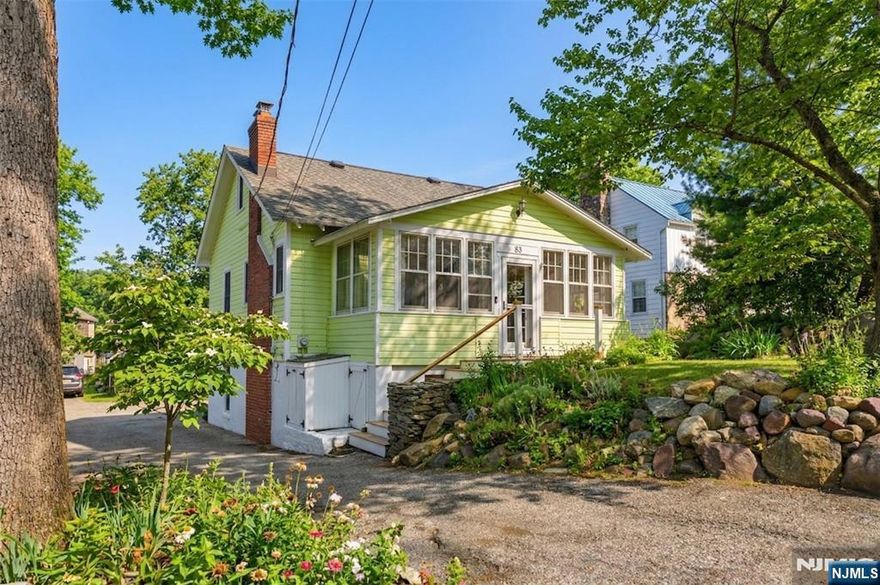 Charming 3 bdrm, 2 full bath Cape lake home in Denville's sought after Indian Lake community, blending timeless character with thoughtful updates. This inviting home showcases hardwood floors, exposed beams, custom built-ins, rich wood trim, & a painted white brick wood-burning fireplace that anchors the cozy living space. The updated kitchen features white cabinetry & flows effortlessly for everyday living & entertaining into the dining room. A sun drenched enclosed front porch with cedar ceiling & beadboard paneling offers the perfect place to relax & unwind. Enjoy additional living space in the full walkout basement with family room, storage, & direct access to a patio. Outdoor living shines with a large deck, fenced level yard, storage shed, & a stunning stone outdoor fireplace ideal for entertaining or peaceful evenings. Eastern front-facing orientation provides beautiful natural light, along with sunset & lake views. Major updates include a brand new gas boiler and kitchen remodel. A long driveway offers ample parking. Optional membership to the Indian Lake community provides year round lifestyle amenities including 3 beaches, clubhouse, motor boating, fishing, ice skating, & community events. Conveniently located within walking distance to Franklin Rd beach & just minutes to DWTN Denville's shops, restaurants, & vibrant events, plus NJ Transit trains, NYC bus access & major hwys, perfect for commuters seeking charm, convenience, & lake living. Flex zone for Elementary