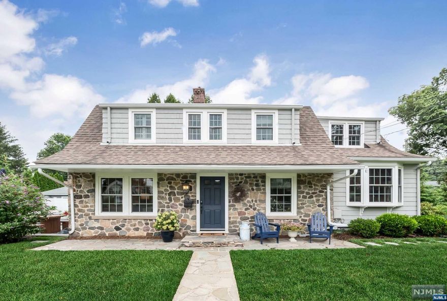 You will fall in love with this charming Dutch colonial with the perfect mix of classic charm and modern amenities. Step inside and find a beautiful living room with wood-burning fireplace & built-in cabinetry, modern dining room with paneled walls & a spacious family room/den. The kitchen is updated with quartz countertops, stainless steel appliances & marble backsplash. Upstairs there are 3 bedrooms including a primary suite with gorgeous primary bath, along with an updated hall bath. Finished lower level adds living space. This home is set on a large level property with new patio, landscaping, hot tub & more. Central air. New windows. Electric Car charger in attached garage. Top-rated school district. This is the one!