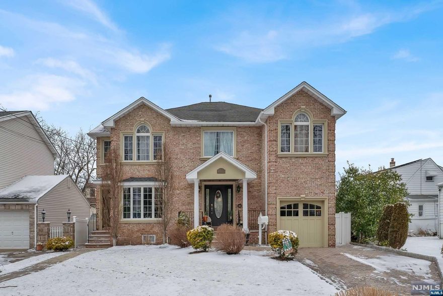 Welcome home to this impressive all brick custom built two-family home boasting 3,882 sq. feet of lavish living. Upon entry, marvel at the gleaming hardwood floors that span the dining room and chef's kitchen equipped with stainless steel appliance, massive island, abundant storage, and space to accommodate multiple people. Step down into your large sunken living room featuring a fireplace, tall ceilings and large windows offering amazing natural light. The owner's suite consists of two floors, 3 beds, 2.5 baths, laundry room, attached garage, and fully finished basement. Unit 2 features a living room, dining room, kitchen, W/D room, beautiful full bath, master bedroom and additional bedroom. 2 HVAC systems all utilities are separate. Central air. This home is ideally located within 1 block to NYC bus stop, and close proximity to schools, shopping, dining, and all that this charming town has to offer.