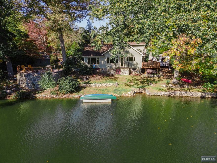 LAKEFRONT HOME, TOTALLY RENOVATED. This fabulous cape cod style home was renovated just 3 years ago with hardwood floors, modern kitchen with stainless steel appliances, all new windows including 3 picture windows overlooking the lake, and a re-furbished original fireplace that has been converted to gas. The gourmet kitchen and open floor plan will keep you endlessly dazzled by the lake for all seasons! First floor primary bedroom has 2 very large closets and a beautiful full bath with large frameless shower glass. Stackable laundry is also first floor combined with powder room. Second floor has 2 large bedrooms, full bath, and huge attic storage space. The full basement has 8 foot ceilings, utilities, and laundry hook ups. Outside patio has invisible railing to enjoy more views of the lake. Detached garage with ground level loft, and detached large shed.