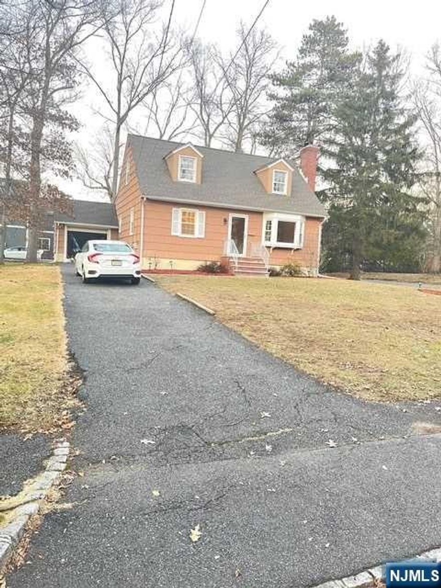 Welcome to this wonderful Cape Cod/Colonial corner lot in best area of Livingston. Step inside and feel right at home then step outside to a huge serene oasis with large deck and yard o entertain all your guests. Walk into a large hardwood floored living room with a wood burning fireplace to cuddle during winter months, then enter into your formal dining room with an open updated kitchen featuring granite countertops, stainless steel refrigerator, gas stove/range, microwave, and dishwasher, finished basement with large lfamily room, media room, excercise room, laundry, and extra storage area. Convenient 1st floor master bedroom and full bath, three bedrooms on 2nd floor with full bathroom. Upstairs, you will find two more spacious bedrooms, extra recreation/storage room and another full bath. Lots of room for expansion in this multi-million dollar home section of Livingston. This one won't last!! Hurry and book your showing right away.