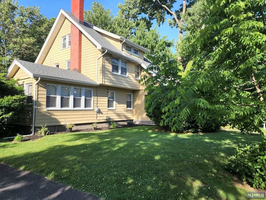 This Large colonial sits on a flat oversized property. It offers EH, Large Living room w/FPL, Full Dining Rm, Den w/FPL, Powder Rm, Large eat in Kitchen, huge screened in Porch. The second floor has three bedrooms and a Full Bath. The Walk up attic has a bedroom w/Sink. It features Hardwood Floors, Central Air, and a Newer Roof. Full Basement with Laundry. Close to schools, shops, houses of worship and NYC Transportation.