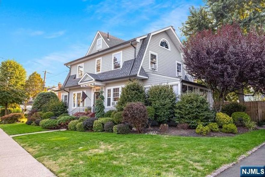 Welcome to this beautifully maintained Colonial, blending natural light with hardwood floors, wood blinds, and charming wood accents. Situated on a picturesque corner lot with lush landscaping and flowering plants, this home features a newer roof (6 yrs), water heater and furnace (both 4 yrs), stainless steel GE Profile appliances, designer lighting, and freshly painted interiors. The 1st floor offers a powder room and modern eat-in kitchen, plus 2 cozy stone fireplaces, one in the dining room and one in the den/office. The heated and cooled side porch offers interchangeable glass/screen panels. Upstairs, the central stairway leads to 4 bedrooms and an updated full bath. The walk-up attic includes additional storage and a cedar closet. The full, partially finished basement includes a kitchenette, closet space, full bath, and plenty of linen storage. A private, fenced-in backyard and detached garage complete the home. A short walk to Cooper's Pond, shopping, restaurants, and more!