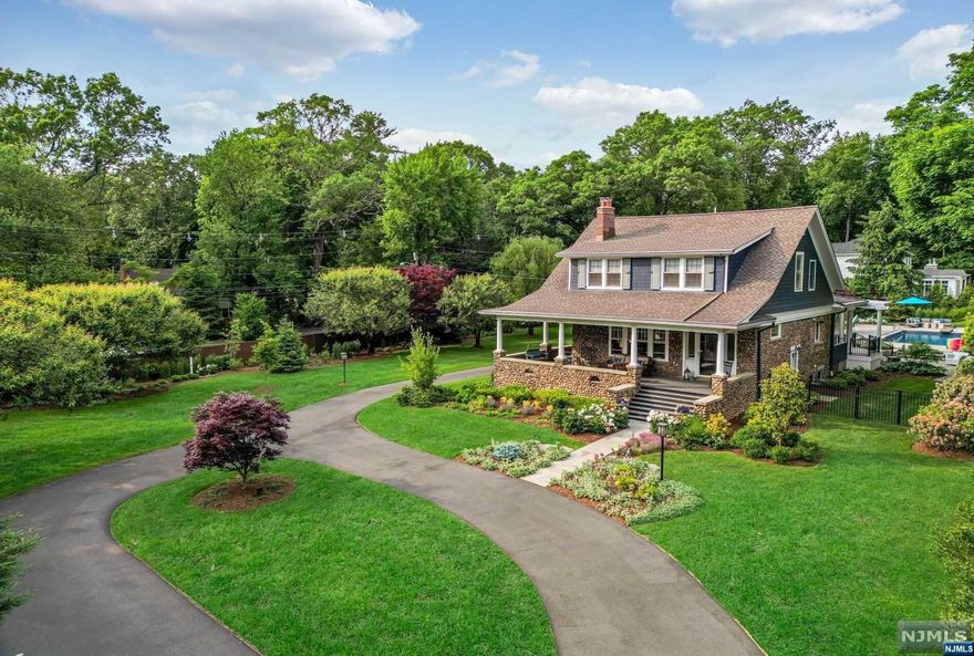 Step into a world where history meets elegance in this breathtaking turn-of-the-century estate. Nestled amidst lush landscaping, this home effortlessly blends the charm of yesteryear with modern amenities. Step inside to discover chestnut finishings, stained glass windows, fireplaces, and stone-work frozen in time. The open layout surrounds a high-quality gourmet kitchen. The sun-drenched master suite boasts an elegant bath, fireplace, and a floor from a 200+ yr old French chateau. Additional features include an in-ground pool,wrap-around porch,3-car garage,newer HVAC systems,roof, and windows. Impeccably maintained, this Craftsman-Style Colonial offers 4 beds,3.5 baths, and custom details throughout. The luxurious master suite showcases a fireplace and overlooks the beautifully landscaped backyard with heated pool. Built-in 1932, it exudes old-world charm with modern amenities. Schedule a private showing today to immerse yourself in the captivating story of this remarkable home.