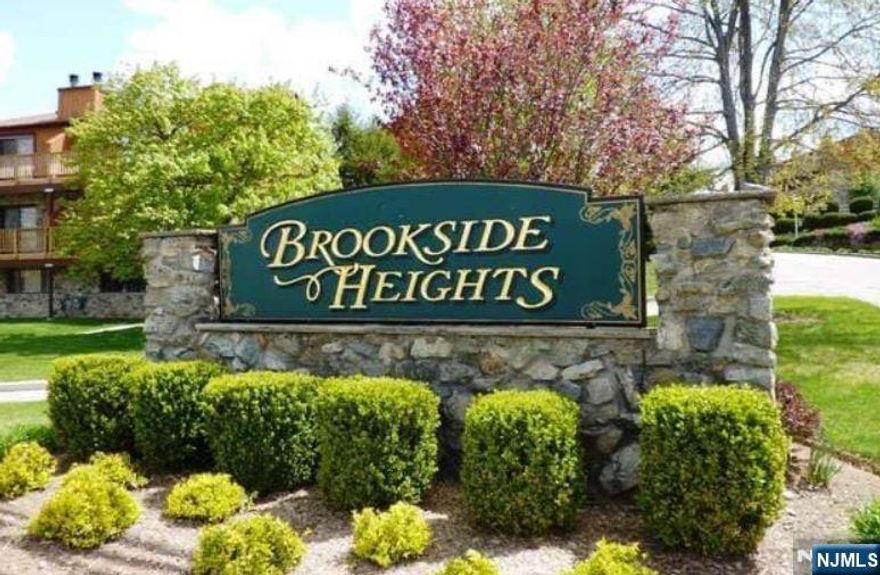 Welcome to Brookside Heights, Wanaqueâ€™s most sought after, pet-friendly townhouse community. This thoughtfully updated end-unit is bathed in natural light and offers beautiful views. Step inside to find gorgeous flooring and an inviting layout. The spacious living room flows seamlessly into the dining room, where a charming stone fireplace creates a warm and cozy ambiance. The gourmet kitchen is a true showstopper, featuring modern finishes and a large deck perfect for outdoor dining and grilling. The main level also includes a convenient half bath and a laundry area for ultimate ease. Upstairs youâ€™ll find two private bedroom suites, each with its own full bath and private balcony, offering the perfect retreat. The finished walk-out basement provides even more living space! Ideal for entertaining, a home office, or a recreation area, plus ample storage. Enjoy resort-style living with access to the clubhouse and pool. 2 Assigned Parking spots!