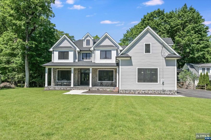 Your dream home awaits! This custom Colonial features 6 bedrooms, 5 full baths, and 2 half baths. The entry foyer leads to a living room and formal dining room with a butler's station. The chef's kitchen boasts custom cabinetry, stainless steel appliances, a center island, and a walk-in pantry, flowing into the breakfast room and family room with a fireplace. The first floor includes a guest bedroom with an en suite, a powder room, a mudroom, and a 3-car garage. Upstairs, the primary suite features a spacious bedroom, sitting area, expansive walk-in closet, and a luxurious bathroom. Two additional bedrooms with walk-in closets and a fifth bedroom with an en suite and walk-in closet are also on this floor, along with a laundry room. The finished walkout basement includes a sixth bedroom with an en suite, a home gym, a rec room, a powder room, and ample storage space.